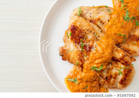 grilled chicken steak with red curry sauce 95897092