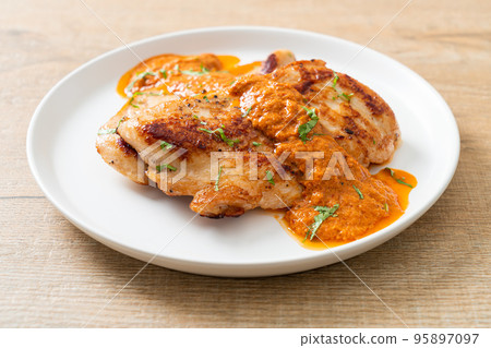 grilled chicken steak with red curry sauce 95897097