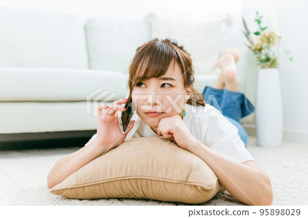 A Japanese woman who gets angry while calling on a smartphone (worried) A Japanese woman who gets angry while calling on a smartphone (worried) 95898029