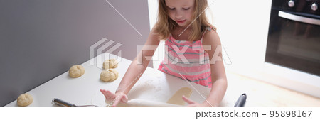 Child girl with rolling pin for baking cookies for dough Child girl with rolling pin for baking cookies for dough 95898167