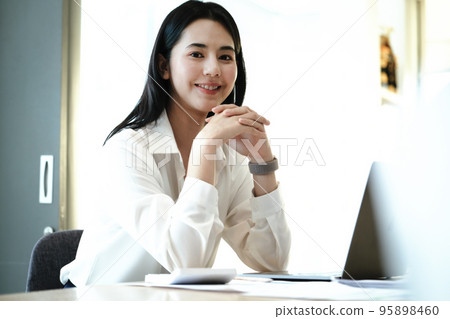 Female employees are working at home through computers to maintain social distancing to reduce the spread of coronavirus 95898460