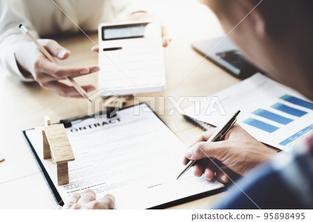 estate agent gives pen and documents agreement with customer to sign contract. Concept agreement 95898495