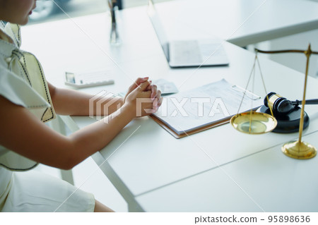 Law and legitimacy, woman holding hands expressing concern during litigation consultation with lawyer. Law and legitimacy, woman holding hands expressing concern during litigation consultation with lawyer. 95898636