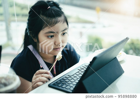 E-learning ,online education and internet social distancing protect from COVID-19 viruses concept. Asian children student video conference e-learning with teacher on tablet computer at home 95898880