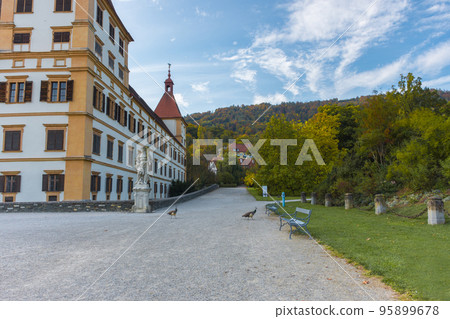 Colorful autumn colors, bright blue sky in the park and Eggenberg Palace in Graz, Styria region, Austria Colorful autumn colors, bright blue sky in the park and Eggenberg Palace in Graz, Styria region, Austria 95899678