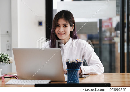 new normal, a businesswoman useing computer to work for a company Via the internet on your desk at home 95899861