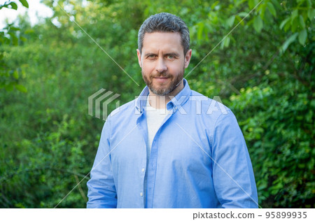 Handsome professional guy in blue shirt natural background Handsome professional guy in blue shirt natural background 95899935