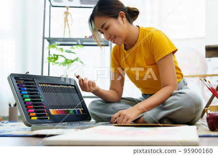 Portrait of an Asian woman designing art in her spare time Portrait of an Asian woman designing art in her spare time 95900160