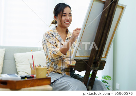 Portrait of an Asian woman designing art in her spare time Portrait of an Asian woman designing art in her spare time 95900576
