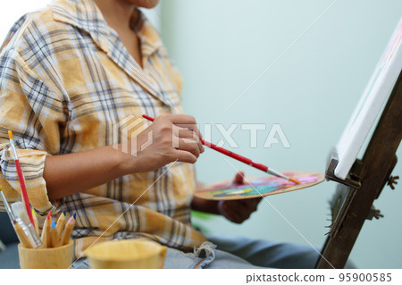 Portrait of an Asian woman designing art in her spare time Portrait of an Asian woman designing art in her spare time 95900585