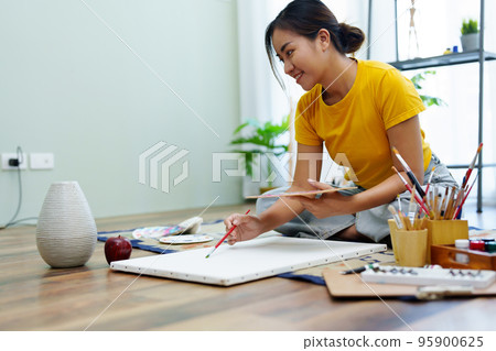 Portrait of an Asian woman designing art in her spare time Portrait of an Asian woman designing art in her spare time 95900625