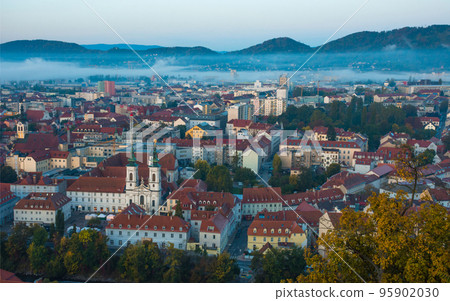 Cityscape of Graz with Mur river and Mariahilfer church (Mariahilferkirche), view from the Shlossberg hill, in Graz, Styria region, Austria 95902030