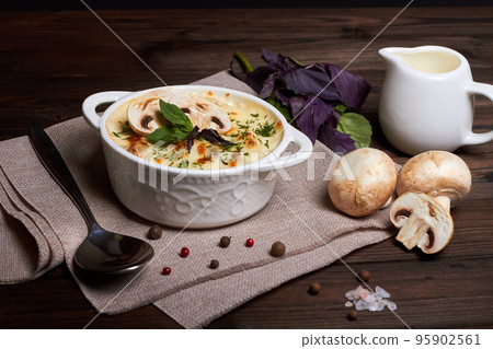 Chicken julienne with cheese, mushrooms and herbs in white plate on wooden board Chicken julienne with cheese, mushrooms and herbs in white plate on wooden board 95902561