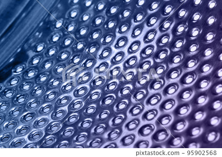 Close-up of inside of a steel washing machine drum Close-up of inside of a steel washing machine drum 95902568