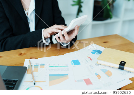 financial, Planning, Marketing and Accounting, portrait of Asian employee checking financial statements using documents and calculators at work.. 95902620