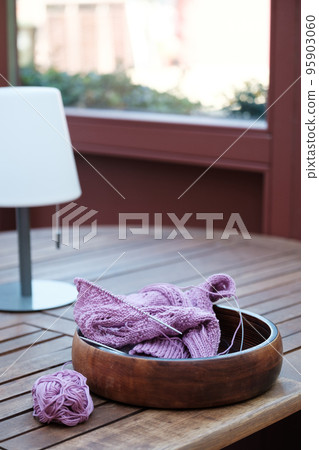 Knitting project of knitting women's pink sweater in progress. 95903060