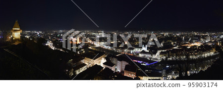 City lights of Graz and the famous clock tower (Grazer Uhrturm) on Shlossberg hill, Graz, Styria region, Austria, by night. Panoramic view. City lights of Graz and the famous clock tower (Grazer Uhrturm) on Shlossberg hill, Graz, Styria region, Austria, by night. Panoramic view. 95903174