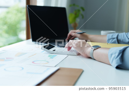 Accountants, Asian auditors are using calculators and computers to review annual tax budgets to submit information to the IRS 95903515