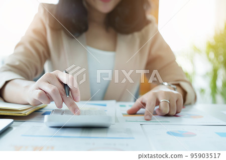 Accountants, Asian auditors are using calculators and computers to review annual tax budgets to submit information to the IRS Accountants, Asian auditors are using calculators and computers to review annual tax budgets to submit information to the IRS 95903517
