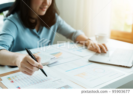 financial, Planning, Marketing and Accounting, portrait of Asian employee checking financial statements using documents and computer at work.. financial, Planning, Marketing and Accounting, portrait of Asian employee checking financial statements using documents and computer at work.. 95903677
