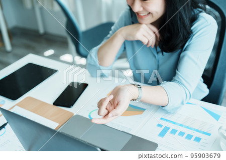Portrait of a beautiful Asian teenage girl using computer for video conferencing at office. Portrait of a beautiful Asian teenage girl using computer for video conferencing at office. 95903679