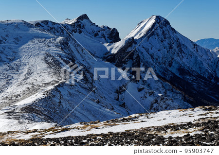 Yatsugatake mountain range, Mt. Yokodake and Mt. Akadake seen from Iodake in winter 95903747