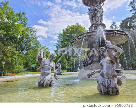 Beautiful fountain in the city park Stadtpark, a green island in the middle of the city center of Graz, Styria region, Austria. Selective focus Beautiful fountain in the city park Stadtpark, a green island in the middle of the city center of Graz, Styria region, Austria. Selective focus 95903788