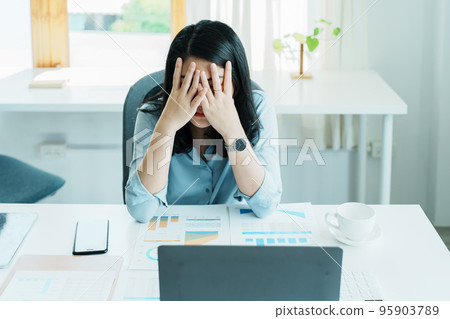 Portrait of sme business owner, woman using computer and financial statements Anxious expression on expanding the market to increase the ability to invest in business. 95903789