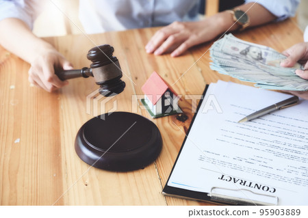 Legal and contract concepts, focus to gavel with contract documents and home purchase payments 95903889