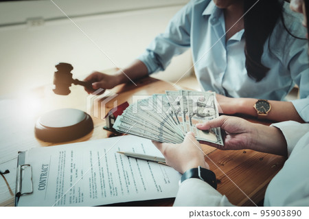 Legal concepts and contracts It focuses on women holding dollars with contract documents and home purchase payments 95903890