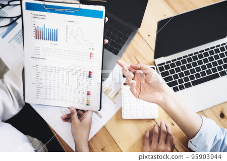 A female business consultant describes a marketing plan to set business strategies for women business owners A female business consultant describes a marketing plan to set business strategies for women business owners 95903944