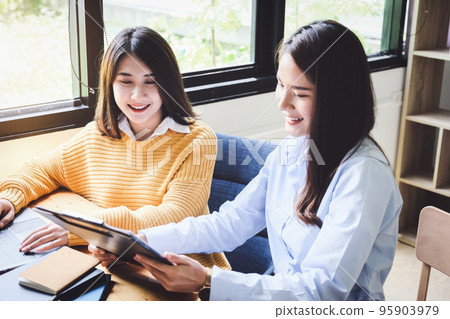 A female business consultant describes a marketing plan to set business strategies for women business owners A female business consultant describes a marketing plan to set business strategies for women business owners 95903979