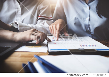 A female business consultant describes a marketing plan to set business strategies for women business owners A female business consultant describes a marketing plan to set business strategies for women business owners 95904034