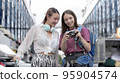 Young women of different nationalities travel together happily. 95904574