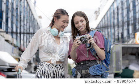 Young women of different nationalities travel together happily. Young women of different nationalities travel together happily. 95904574