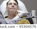 White man is removing wrinkles and rejuvenating facial skin by a specialist doctor 95904576