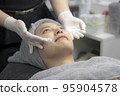 Young women facials from beauty experts. 95904578