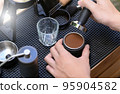Barista making slow bar coffee. 95904582