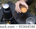 Beautiful crema coffee in a glass. 95904586