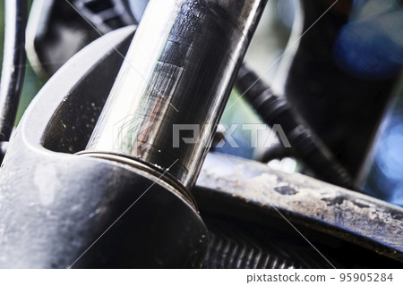 Macro shot of shock absorber on front fork of bicycle 95905284