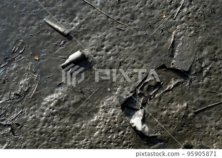 Mud, garbage and dust on wet soil texture Mud, garbage and dust on wet soil texture 95905871