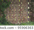 wall made with terracotta bricks arranged diagonally to create vent holes in an old farm 95906363