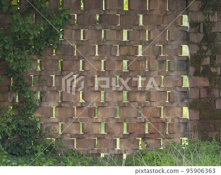 wall made with terracotta bricks arranged diagonally to create vent holes in an old farm wall made with terracotta bricks arranged diagonally to create vent holes in an old farm 95906363