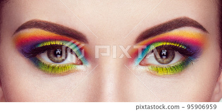 Female eye with  rainbow make-up 95906959