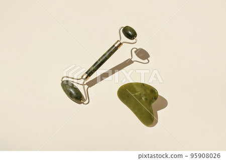 Natural crystal massage roller for self-care. Spa tool for relaxation and facial skin care. Natural crystal massage roller for self-care. Spa tool for relaxation and facial skin care. 95908026