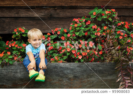 Little child have a fun in tropical garden Little child have a fun in tropical garden 95908083
