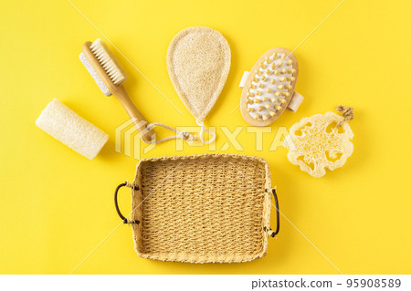 Anti cellulite massager, loofah sponge on yellow surface. Zero waste, reduce plastic concept. Sustainable lifestyle. 95908589