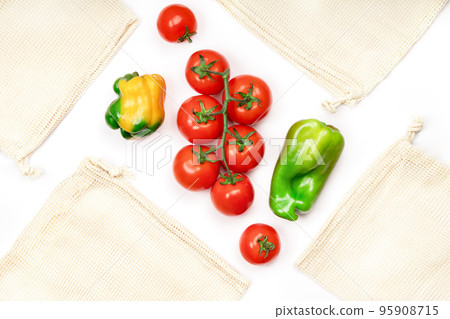 Creative layout of fresh vegetables and reusable eco friendly bags on white, top view. Sustainable lifestyle. Ecofriendly food shopping. Zero waste concept. Creative layout of fresh vegetables and reusable eco friendly bags on white, top view. Sustainable lifestyle. Ecofriendly food shopping. Zero waste concept. 95908715