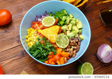 Salad texas caviar. Vegetable dish with corn, beans, pepper, pepper, tomatoes, beans. Served with corn chips nachos Salad texas caviar. Vegetable dish with corn, beans, pepper, pepper, tomatoes, beans. Served with corn chips nachos 95909118