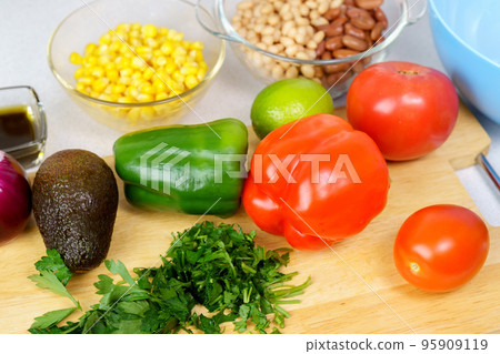 Salad texas caviar. Vegetable dish with corn, beans, pepper, pepper, tomatoes, beans. Served with corn chips nachos Salad texas caviar. Vegetable dish with corn, beans, pepper, pepper, tomatoes, beans. Served with corn chips nachos 95909119